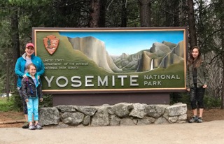 Family in front of Yosemite sign